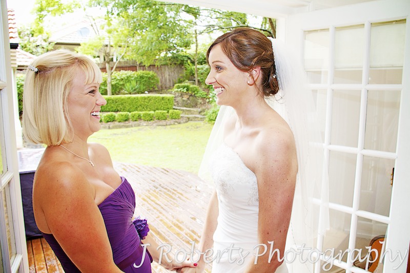 Bride and bridesmaid laughing and having fun - Wedding Photography Sydney